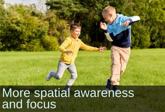 Two boys playing tag. Text: More spacial awareness and focus.